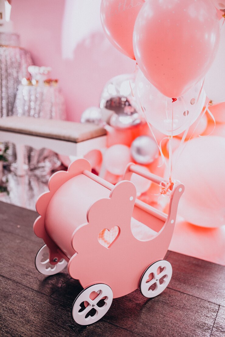 Free Photo little wooden baby stroller toy at a baby shower party