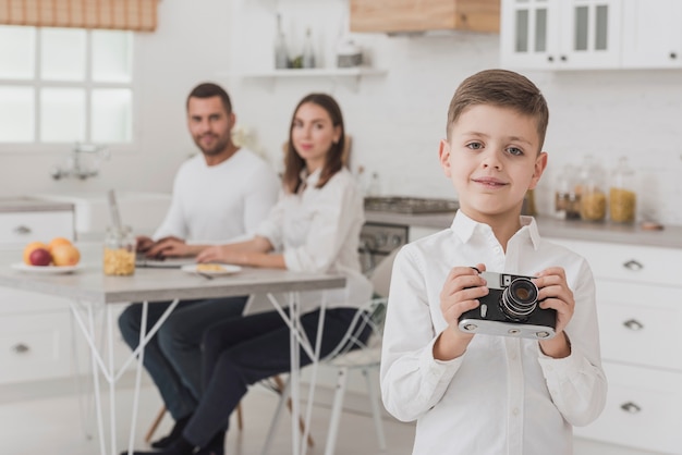 Little young boy holding camera