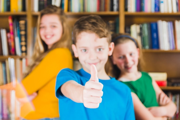 Lively kids standing in library 