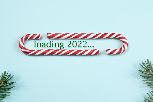 Loading panel in christmas style, the inscription loading 2022 on a blue background. the concept of the new year.