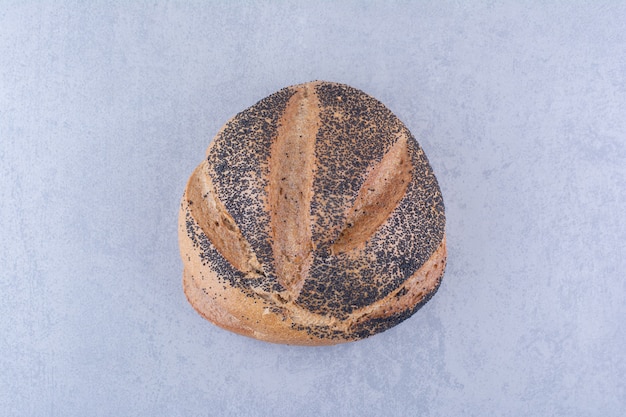 Free photo loaf of black sesame coated bread on marble surface