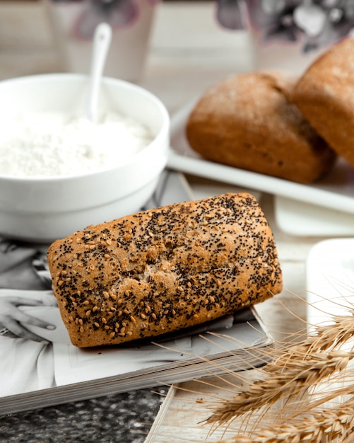 Loaf of bread topped with poppy and sesame seeds