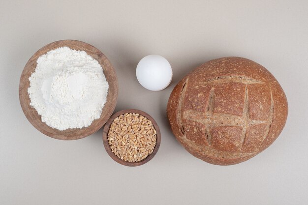 Loaf of bread with boiled egg and oat grains