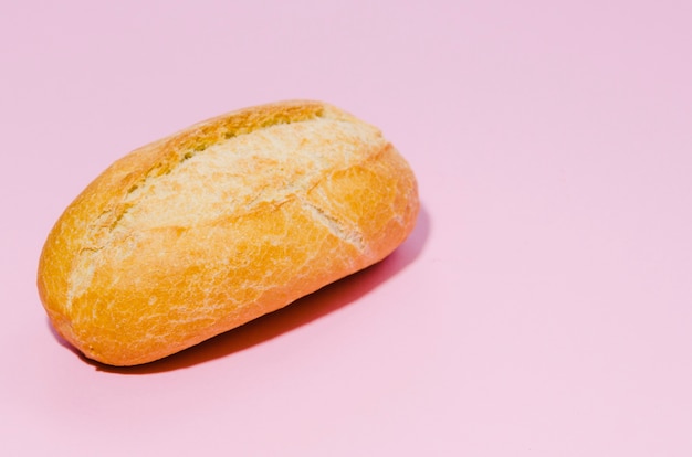 Free photo loaf of bread with color background