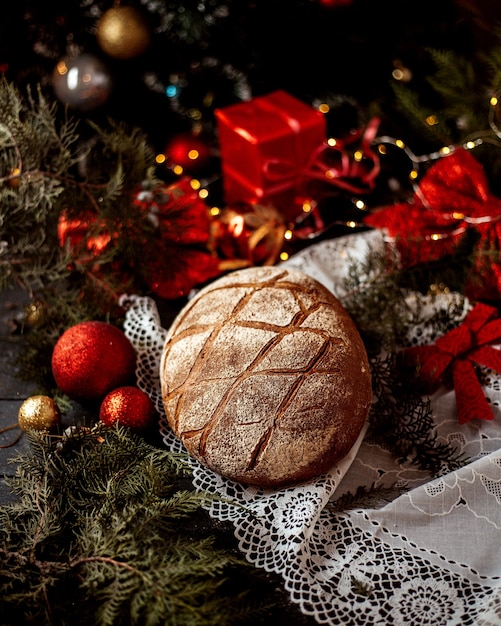 Free photo a loaf of bread with new year toys