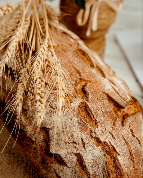 Free photo loaf of bread with  wheat branch