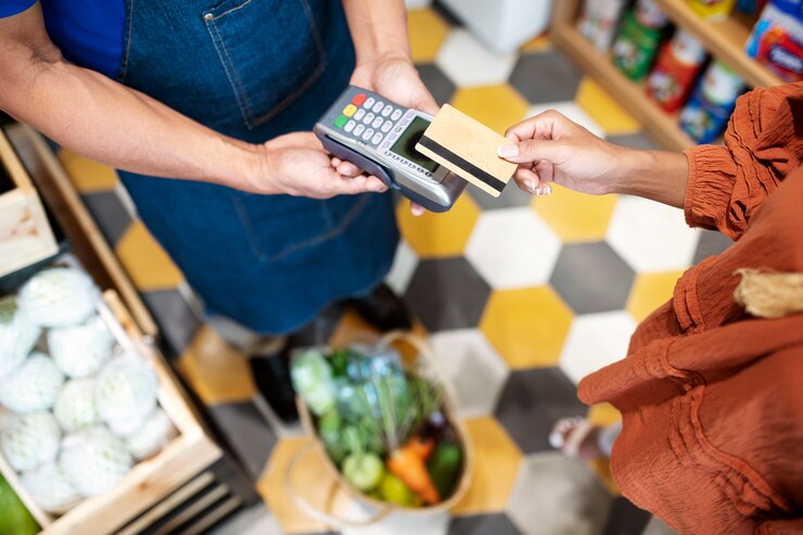 Free Photo local retailer helping his client to pay