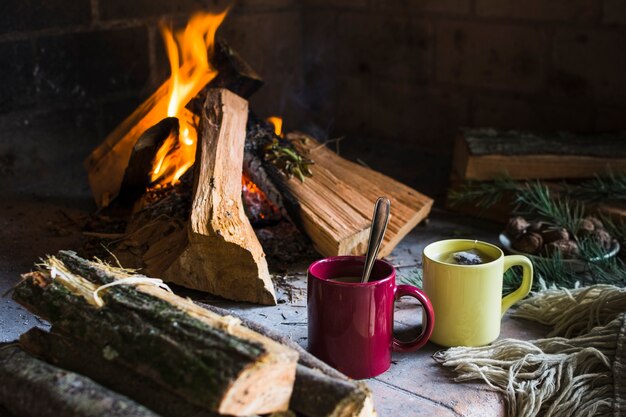 Logs and beverages near fireplace