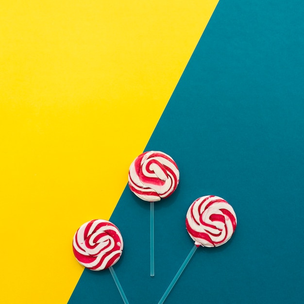 Lollipops on yellow and blue background