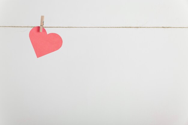 Lone paper heart hanging on rope