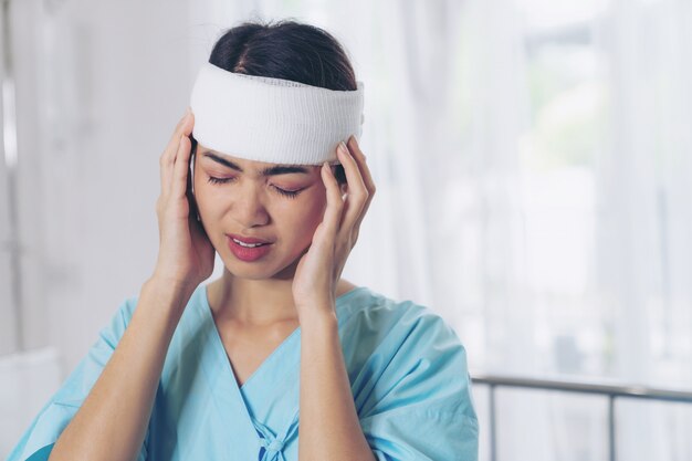 Lonely accident patients injury headache woman in hospital - medical concept