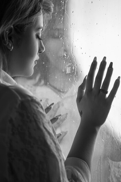 Lonely girl near window thinking about something