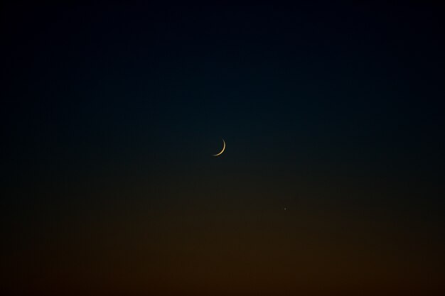 Lonely moon in dark night sky