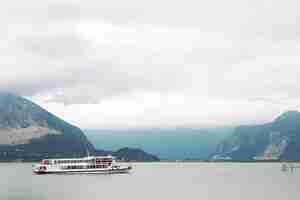 Free photo lonely white boat stands on the sea before the mountains