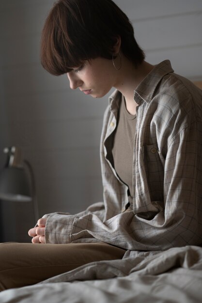 Lonely woman in bedroom medium shot