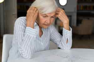 Free photo lonely woman confronting alzheimer disease