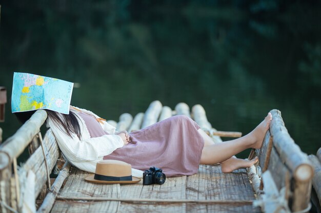 Free Photo lonely woman sitting on the waterfront raft