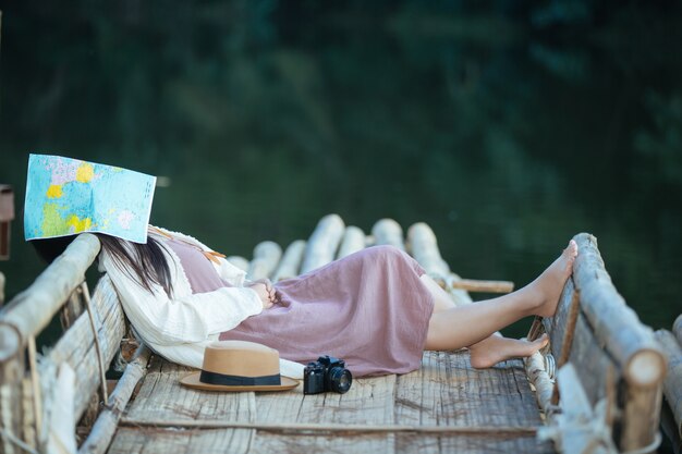 Lonely woman sitting on the waterfront raft