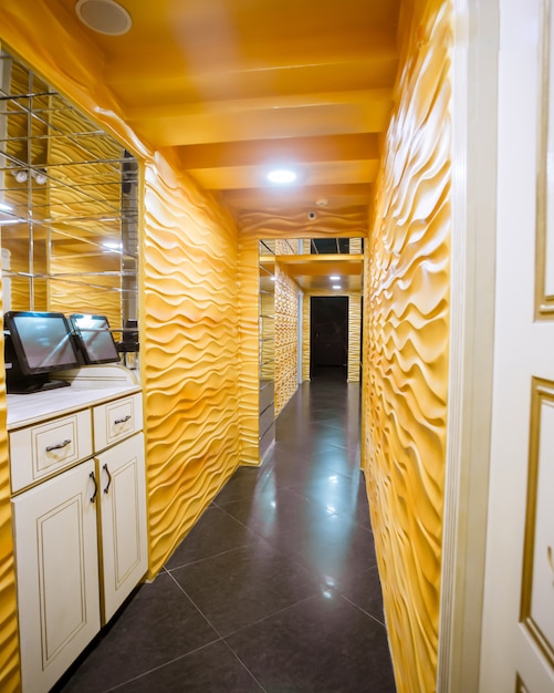 Long corridor with yellow walls and ceiling white doors