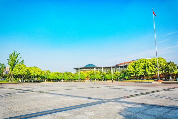 long empty footpath in modern city square with skyline.