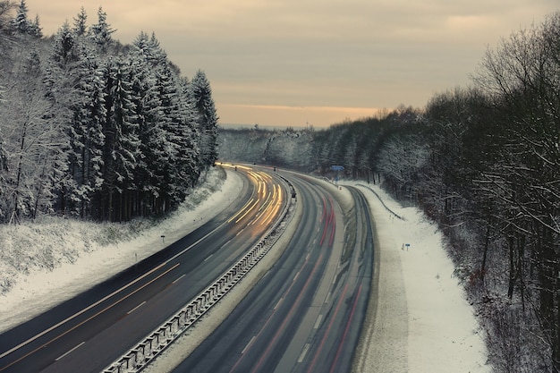 Long exposure shot a motorway in a winterly landscape in the Bergisches Land, Germany at dusk