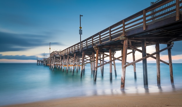 Long exposure shot of a pier on the beach in California