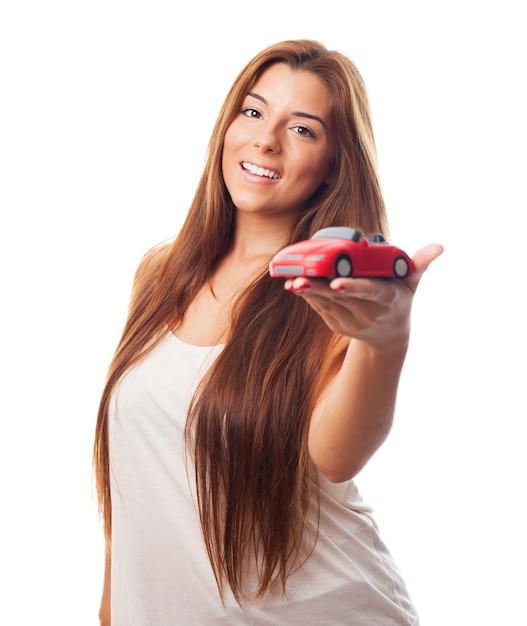 Free photo long haired beauty with tiny car