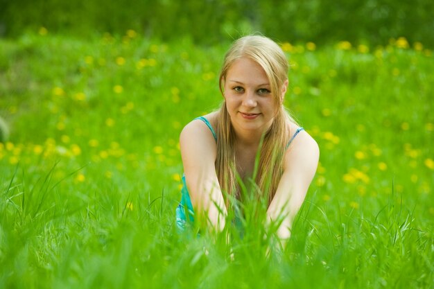 long-haired girl rests on  grass