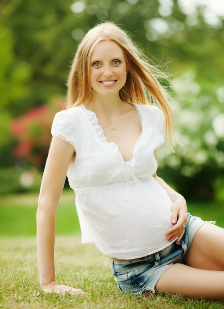 Long-haired happy pregnant woman