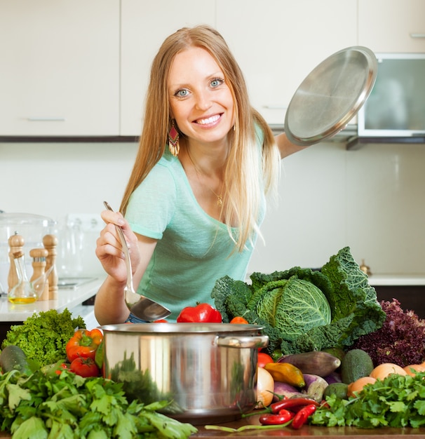 Long-haired woman cooking with ladle