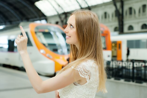 Long-haired woman  at railway station