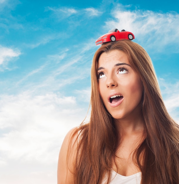 Free photo long-haired woman with a car on her head