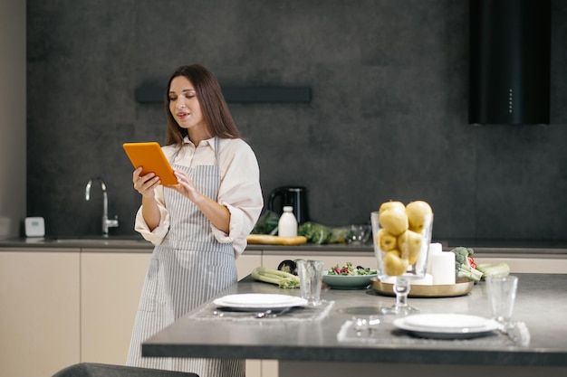 Long-haired young woman thinking about cooking something for lunch