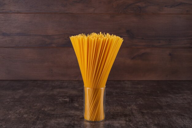 long pasta in glass on a black table