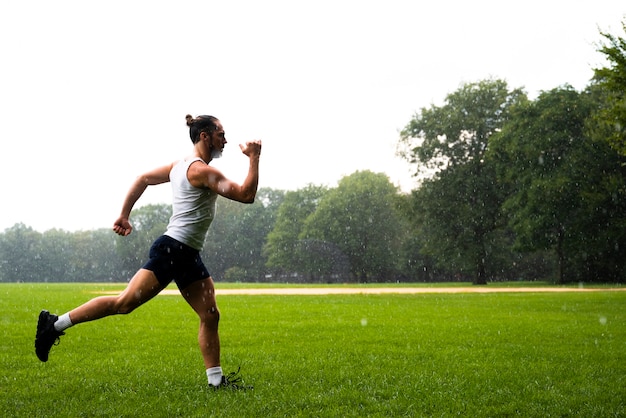 Long shot of athlete running on grass