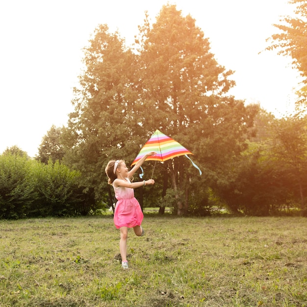 Long shot of beautiful happy girl with kite