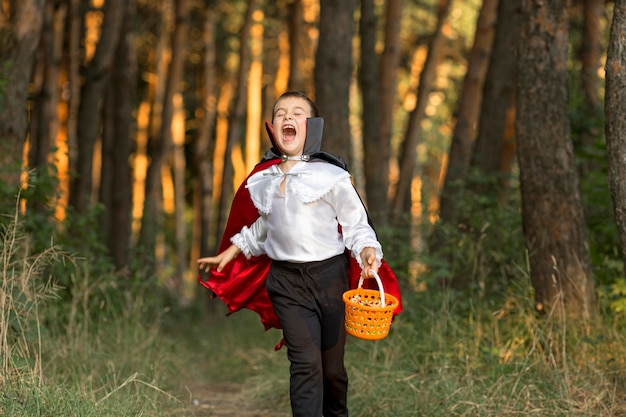 Long shot of boy in dracula costume