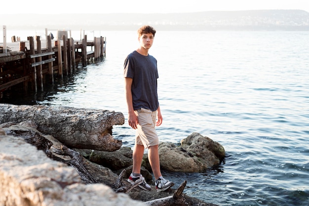 Long shot of boy relaxing at sea