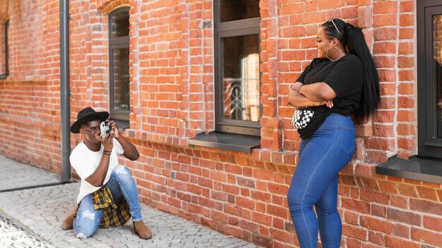 Long shot boy taking a photo of his friend