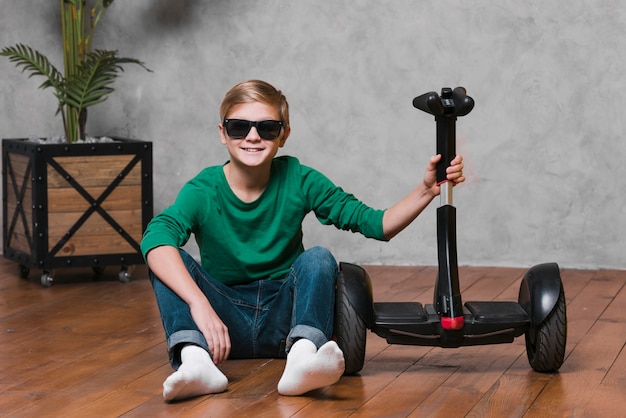 Long shot of boy with hoverboard