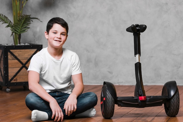 Free photo long shot of boy with hoverboard