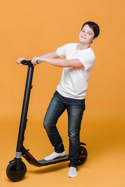 Long shot of boy with scooter