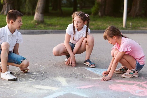 チョークで描くロングショットの子供たち