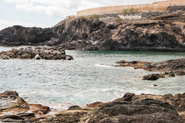 Long shot cliffed coast with crystalline water