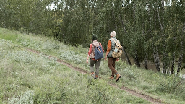 Long shot couple walking up a trail