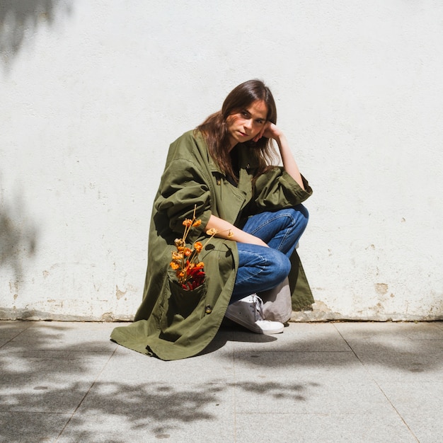 Long shot fashion woman crouching