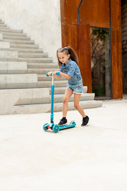 Long shot of girl on blue scooter