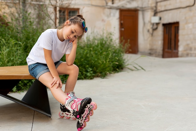 Free photo long shot of girl with inline skates