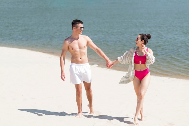 Long shot of happy couple at beach