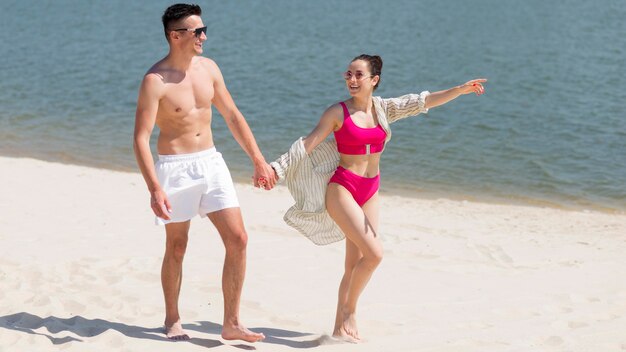 Long shot of happy couple at beach